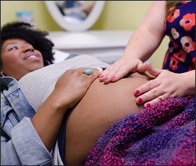 Midwife treating a pregnant patient in Eugene, Oregon